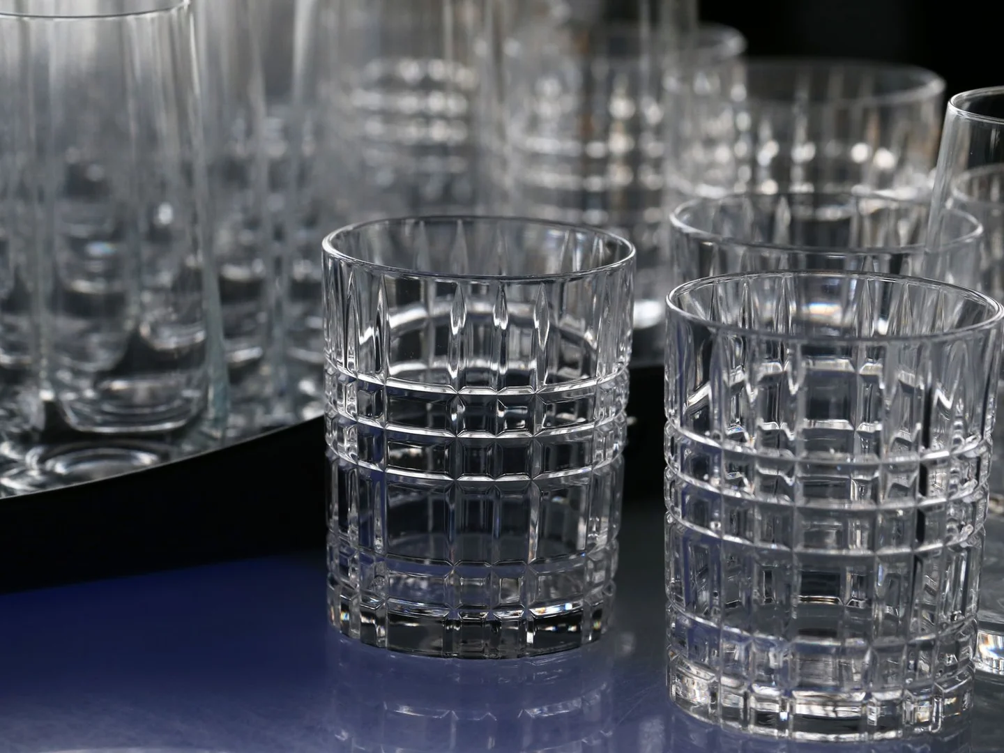 Clear drinking glasses with faceted sides.