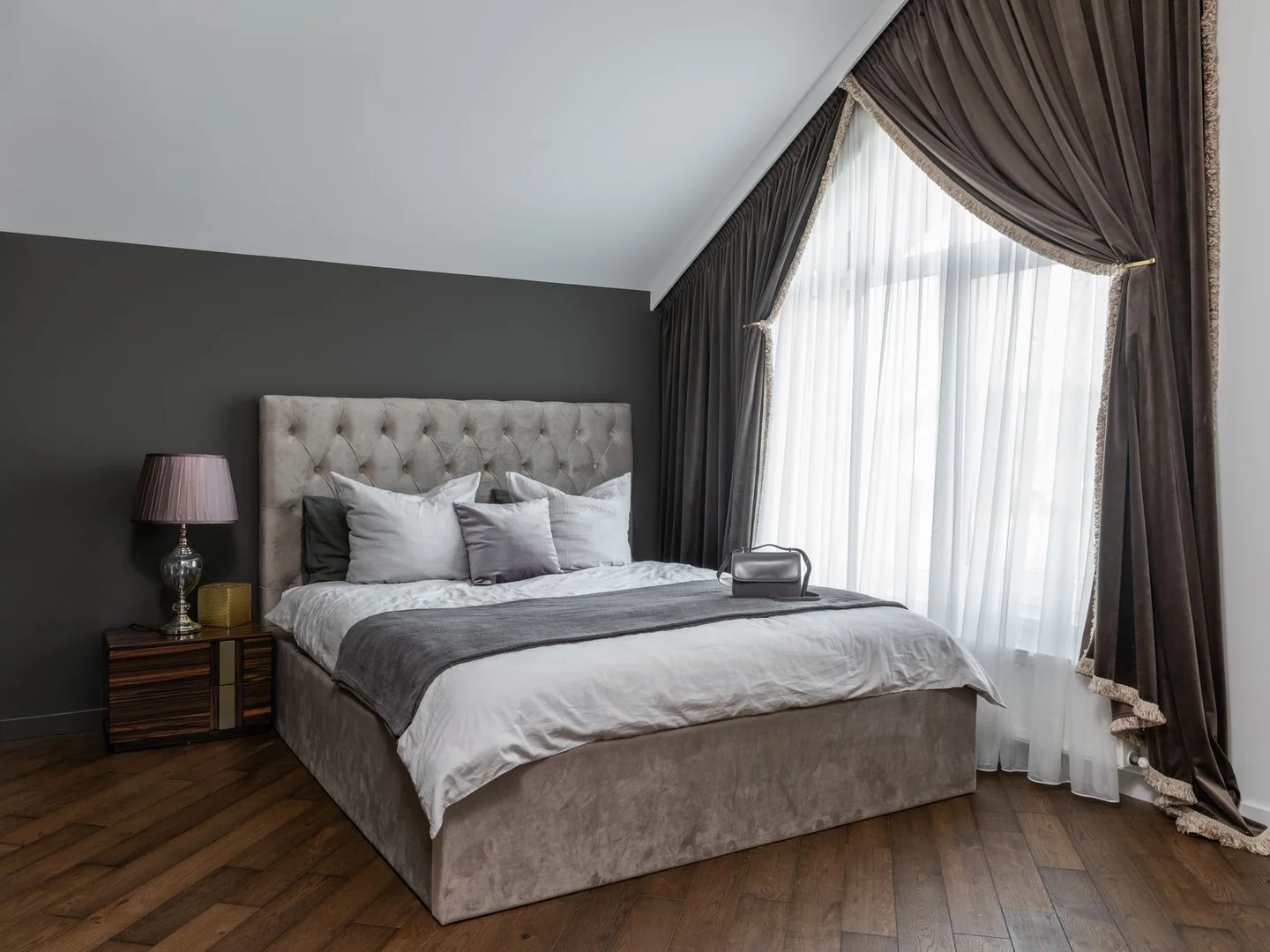 A made bed with a duvet and pillows.
