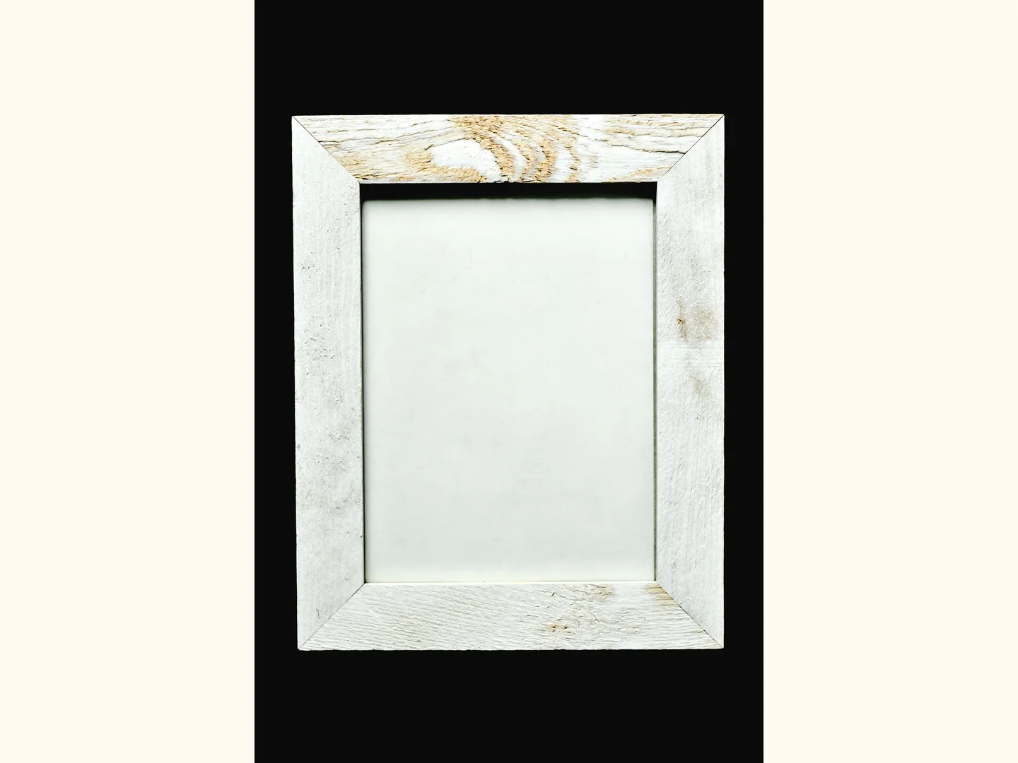 A whitewashed wooden picture frame with an empty center.