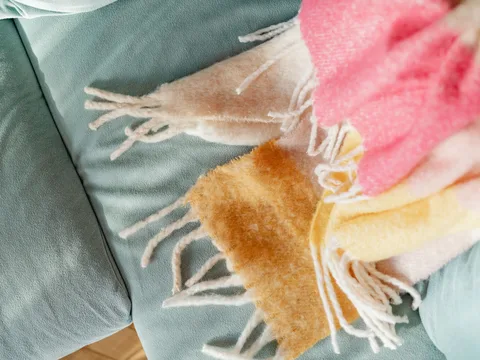 Soft throws draped over a sofa.