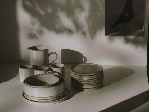 Ceramic dinnerware arranged on a table in bright daylight.