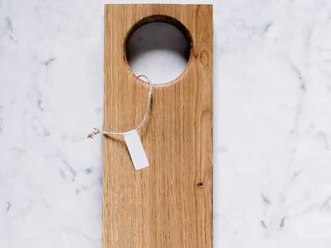 A rectangular wooden cutting board on a marble counter.