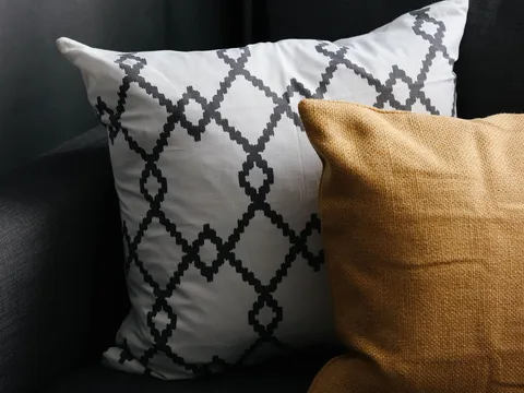 Cushions with different textures on a sofa.
