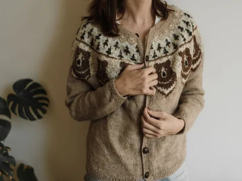 A knitted cardigan with buttons and textured stitching.