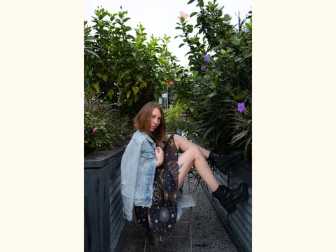 A patterned dress paired with a denim jacket.