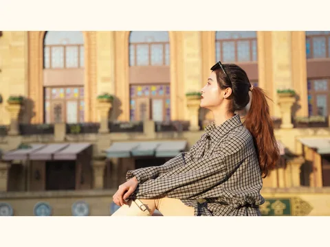 A checked shirt dress worn outdoors.